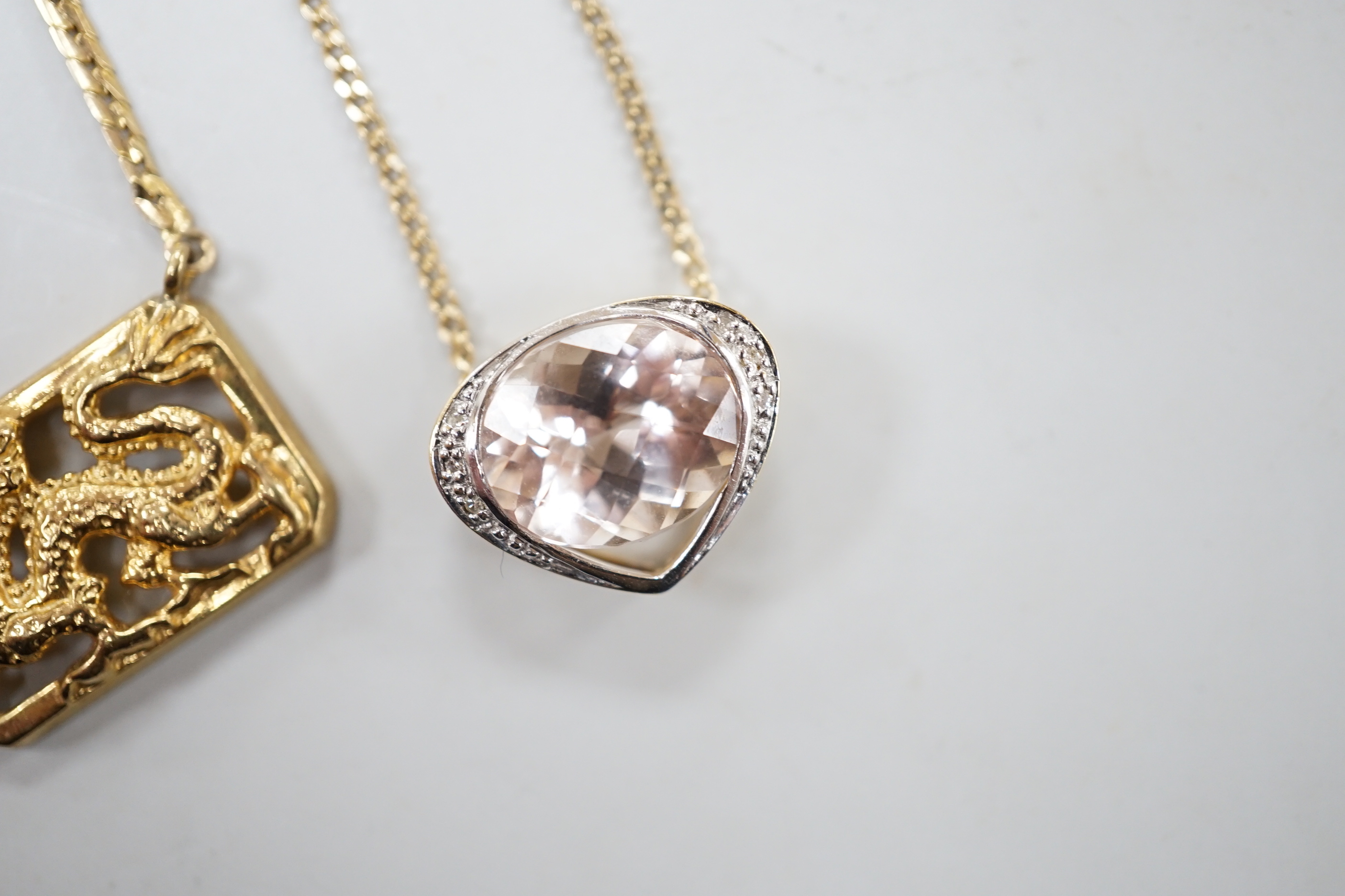 A modern 9ct gold and morganite? set heart shaped pendant necklace, 52cm and a 9ct gold Italian 'dragon' pendant necklace, gross weight 12.8 grams.